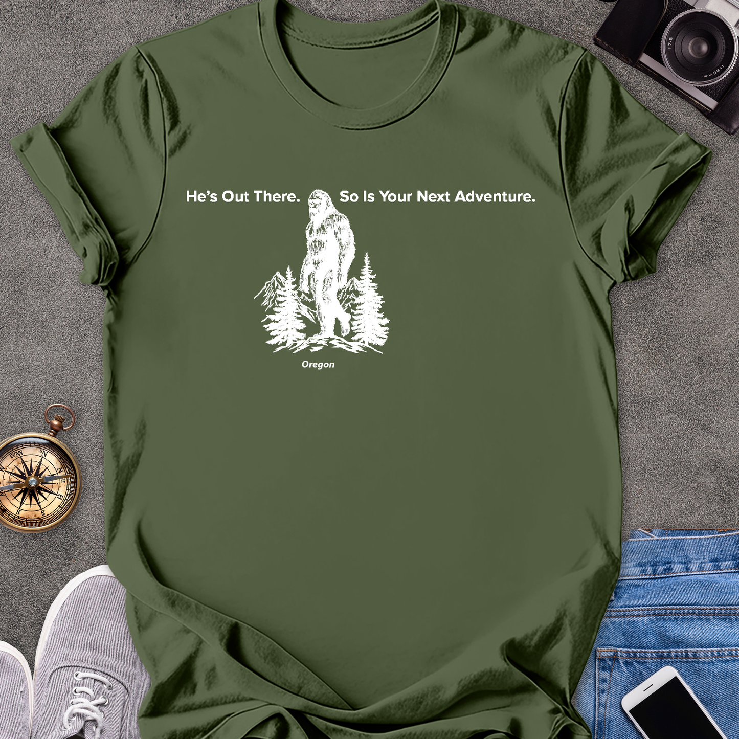 He's Out There. So Is Your Next Adventure - Oregon | Unisex Softstyle T-Shirt | Oregon Bigfoot Travel Tee