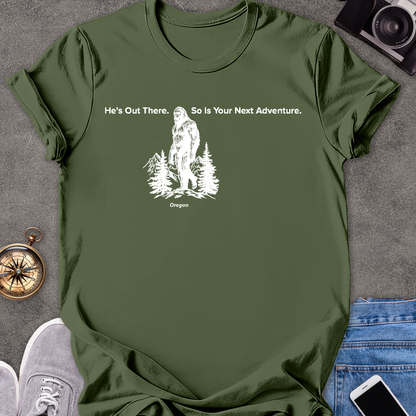 He's Out There. So Is Your Next Adventure - Oregon | Unisex Softstyle T-Shirt | Oregon Bigfoot Travel Tee